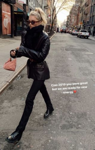 Elsa Hosk walks in Brooklyn in a black leather jacket